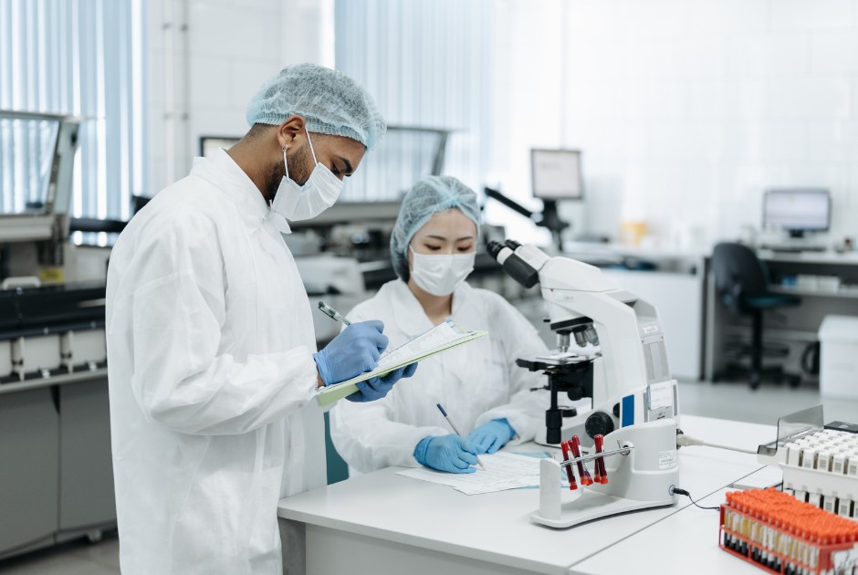 Specialists preparing pharmaceutical-grade treatment in the laboratory