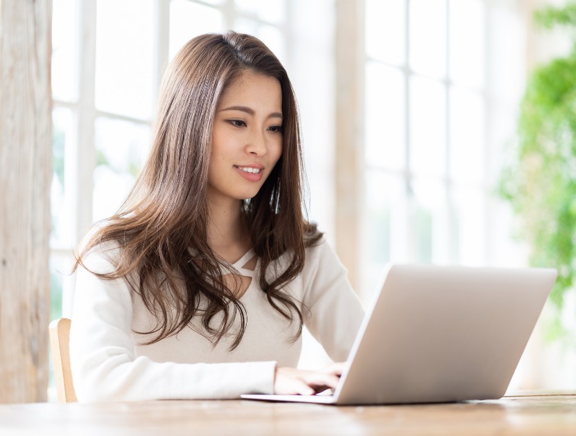 Woman managing home-based treatment on a laptop