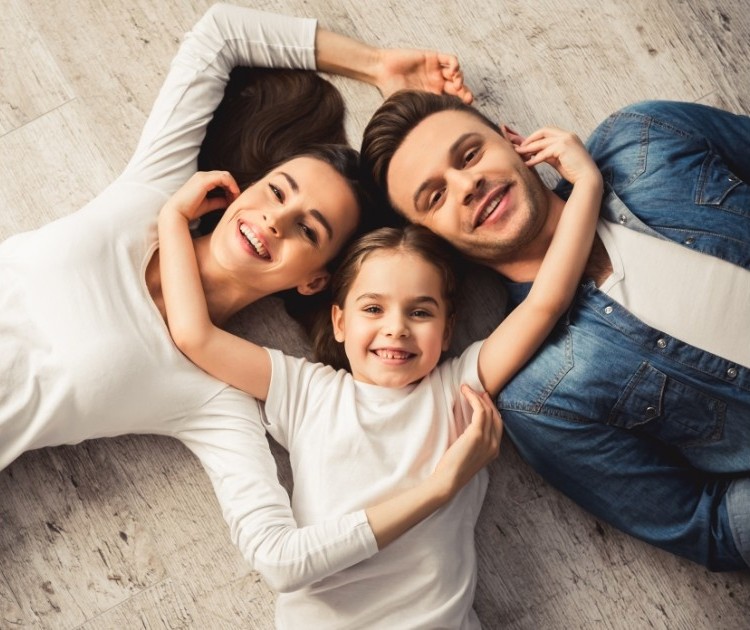Family lying on the floor smiling