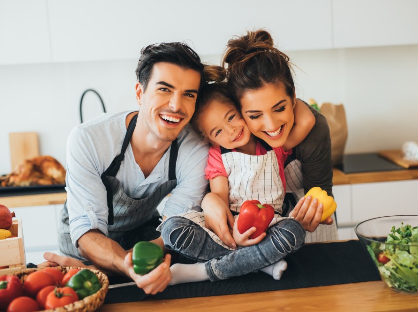 Parents cooking together with their child